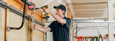 Oklahoma City garage door being serviced to ensure smooth operation and safety.