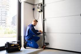 Professional garage door technician in OKC performing repair on a residential door.