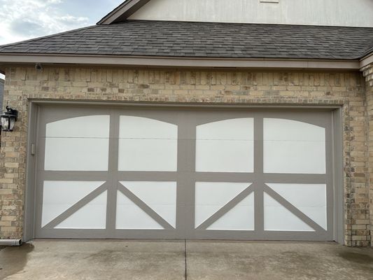 Oklahoma City homeowner inspecting garage door for maintenance and repair.